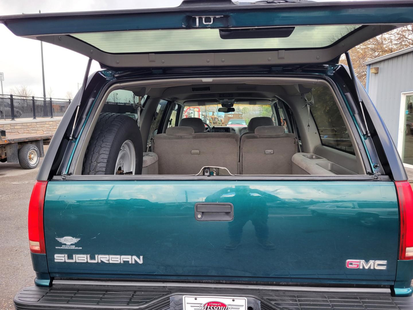 1998 Green /Gray GMC Suburban SLE (3GKFK16R9WG) with an 5.7L V8 engine, 4 Speed Auto transmission, located at 450 N Russell, Missoula, MT, 59801, (406) 543-6600, 46.874496, -114.017433 - 4WD SUV. 5.7L V8 Engine. 4 Speed Automatic Overdrive Transmission. Front and Rear Climate Control. AM FM CD Cassette. Air Cruise. Tilt. Power Front Seats. Power Windows and Locks. Towing. Running Boards. 3rd Row Seating. Because of the Age, financing is not available on this vehicle. - Photo#12